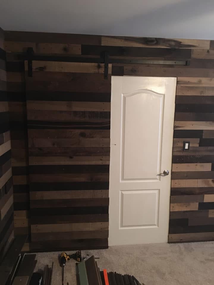 Pallet wood accent wall with sliding door